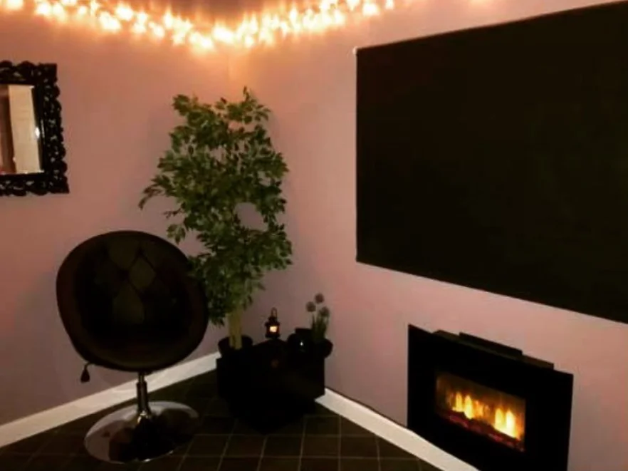 Sa'ha spa relaxation room with cozy fireplace and ambient lighting